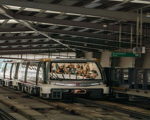 A commuter standing comfortably on the BTS Skytrain